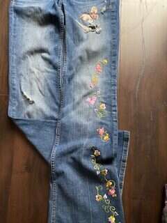 picture showing how I upgrade my old jeans by a press on decorating flower items